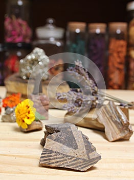 Ancient Native American Pottery Pieces With Crystals and Flowers on Meditation Table