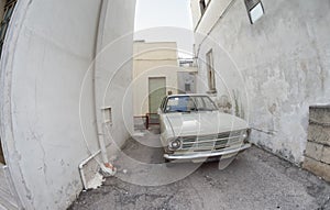 Ancient old automobile in Italy. Car parked in a town street