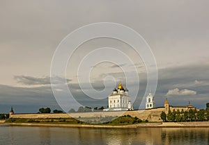 Ancient old fortress on the river bank bright clouds sky July 30rd 2016, Russia - Pskov Kremlin wall, Trinity Cathedral, Bell Towe