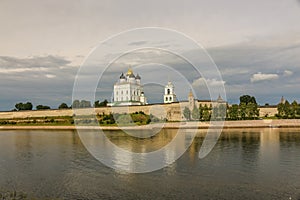 Ancient old fortress on the river bank bright clouds sky July 30rd 2016, Russia - Pskov Kremlin wall, Trinity Cathedral, Bell Towe