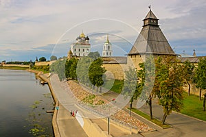 Ancient old fortress on the river bank bright clouds sky July 30rd 2016, Russia - Pskov Kremlin wall, Trinity Cathedral, Bell Towe