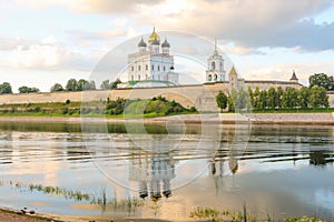 Ancient old fortress on the river bank bright clouds sky July 30rd 2016, Russia - Pskov Kremlin wall, Trinity Cathedral, Bell Towe