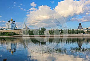 Ancient old fortress on the river bank bright clouds sky July 30rd 2016, Russia - Pskov Kremlin wall, Trinity Cathedral, Bell Towe