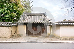 Ancient and old Japanese house gate in Nara, Japan under bright blue sky