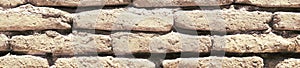 An ancient old rough drystone wall. Background photo. Texture pattern.