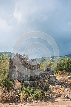 Ancient old ruined tombs against cloudy sky in Turkey