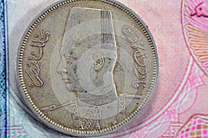 Ancient old ten 10 Egyptian piasters coin at the era of king Farouk I features value and kingdom of Egypt on a side and a bust of photo
