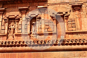 Ancient ornamental dravidian styled wall with sculptures in the Brihadisvara Temple in Thanjavur, india.