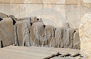 Ancient palace. Bas-relief with servants carrying food supplies, Persepolis, near Shiraz, Iran