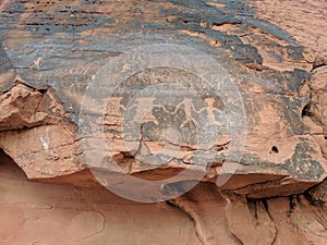 Ancient petroglyphs of people holding hands in Valley of Fire Nevada