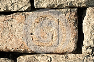Ancient petroglyphs on the stone walls of an old house