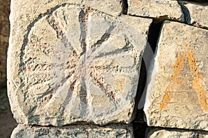 Ancient petroglyphs on the stone walls of an old house