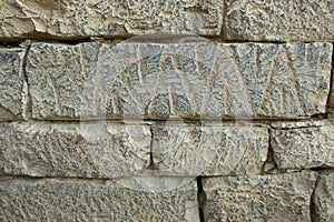 Ancient petroglyphs on the stone walls of an old house