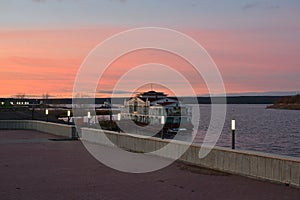 Ancient pier, deserted embankment, pink sunset. Naberezhnye Chelny. Russia.