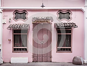 Ancient, pink building with a wooden door