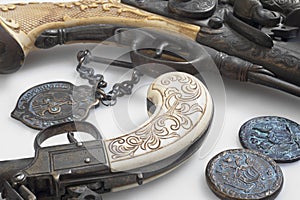 Ancient pistols and old coins.
