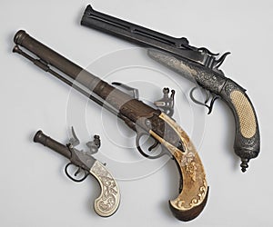 Ancient pistols on white background.