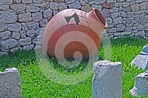 Ancient pithos on the grass