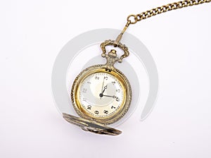 Ancient pocket watch isolated on white with golden chain