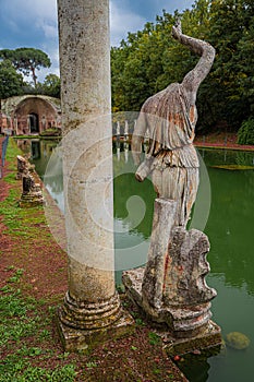 Ancient pool called Canopus, surrounded by greek sculptures in Villa Adriana Hadrian`s Villa, Tivoli, Italy