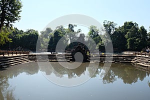 Ancient pool. The pool, the shore and the bottom of which are laid out of stone blocks. Neak Pean. Khmer baray