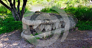 Ancient prehispanic crocodile made of stone photo