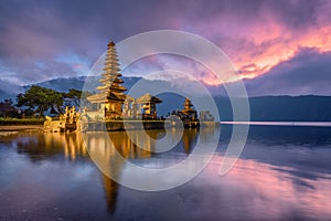 Ancient Pura Ulun Danu Bratan temple reflection with colorful sk