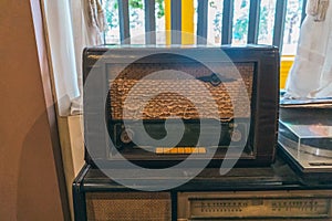 Ancient radio lay on the shelves. Radio on cabinet next to plant. Real photo. retro radio. antique radio