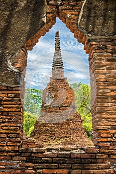 The ancient remains pagoda looked through ruin window in Wat Phra Si Sanphet, Ayutthaya, Thailand