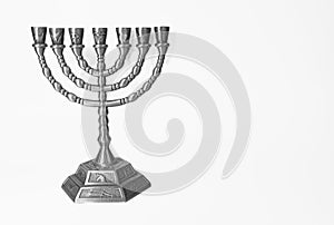 Ancient ritual candle menorah on a white background. Beautiful silver hanukkah menorah