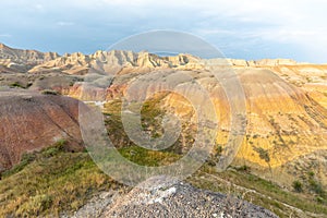 An ancient river bed runs through the eroded, yellow hills of Badlands National Park.