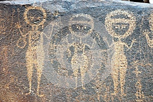 Ancient rock art in Niger depicting three figures