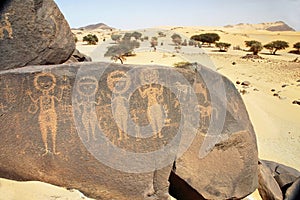 Ancient rock art in Sahara depicting four figures