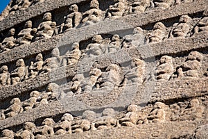 Ancient rock carvings of Jain tirthankaras on a hill photo