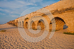 Ancient Roman aqueduct at sunset