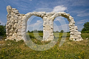 Ancient Roman arches under the sun in Burnum site