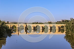 Ancient roman bridge across the Guadalquivir river in the morning