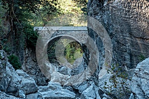 Ancient Roman bridge over a shady gorge in the Kesme Bogazi canyon, Turkey