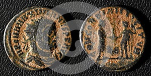 Ancient Roman coin of Emperor Maximian, top view of old metal money isolated on black background. Theme of vintage copper texture