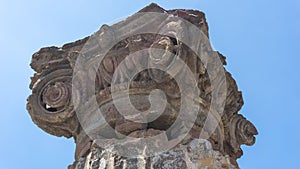 Ancient Roman column capital (head) with blue sky in the background in Pompeii. Pompei, Campania, Italy, July 2020.