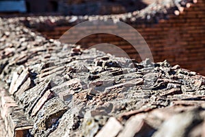 Ancient roman detailed stonework on top of a wall