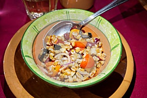 Ancient roman food antipasti pearl barley salad with tomatoes, olives, red onion