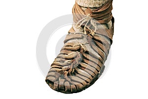 An ancient Roman man legs in caligae leather sandals, isolated on a white background. Reconstruction of the events of the Roman