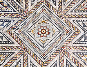 Ancient roman stone mosaic floor with geometric design