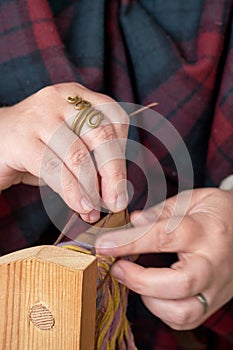 An ancient Roman woman makes yarn and sews from vintage wool. Reconstruction of the events of the Roman Empire