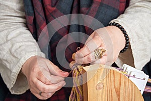 An ancient Roman woman makes yarn and sews from vintage wool. Reconstruction of the events of the Roman Empire