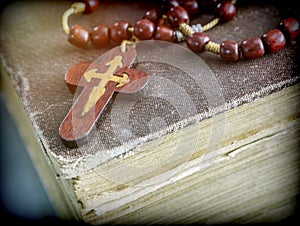 An ancient rosary on an old book