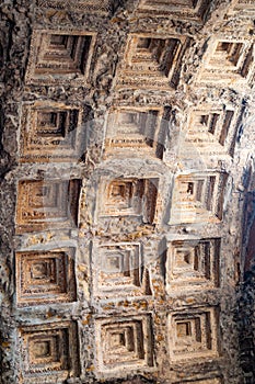 Ancient round cassette ceiling with natural sunlight penetrating through the window