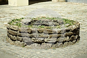 Ancient round stone brick well, little decorated