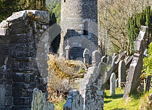 The ancient round tower in the cemetery at the historic Glendalough Monastic Site in County Wicklow in Ireland